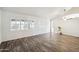 Living room featuring hardwood floors and large windows with shutters at 7869 W Kristal Way, Glendale, AZ 85308