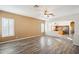 Spacious living room with hardwood floors and views into the kitchen at 7869 W Kristal Way, Glendale, AZ 85308