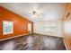 Living room with wood-look floors and orange accent wall at 7869 W Kristal Way, Glendale, AZ 85308