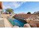 Inviting backyard oasis featuring a sparkling pool and rock waterfall at 7869 W Kristal Way, Glendale, AZ 85308