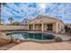 Inviting backyard oasis with a kidney shaped pool and covered patio at 818 W Allen St, Phoenix, AZ 85041