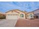 Single-story house with a two-car garage and landscaped yard at 818 W Allen St, Phoenix, AZ 85041