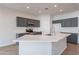 Modern kitchen with stainless steel appliances and an island at 818 W Allen St, Phoenix, AZ 85041