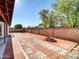 Landscaped backyard with brick pavers, fire pit, and block wall at 10329 W Griswold Rd, Peoria, AZ 85345