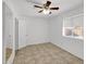 Bright bedroom with ceiling fan and tile floors at 10329 W Griswold Rd, Peoria, AZ 85345