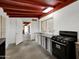 Small kitchen with stainless steel appliances and red ceiling beams at 10329 W Griswold Rd, Peoria, AZ 85345