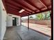 Covered patio with access to backyard, and a red ceiling at 10329 W Griswold Rd, Peoria, AZ 85345