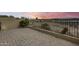 Brick patio with sunset view and a metal fence at 11022 N Indigo Dr # 127, Fountain Hills, AZ 85268