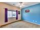 Well-lit bedroom with a ceiling fan and large window at 11022 N Indigo Dr # 127, Fountain Hills, AZ 85268