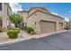 Tan stucco two-car garage with desert landscaping at 11022 N Indigo Dr # 127, Fountain Hills, AZ 85268