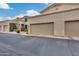 Two-car garage with stucco exterior and flowering vines at 11022 N Indigo Dr # 127, Fountain Hills, AZ 85268