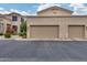 Two-car garage with desert landscaping and stucco exterior at 11022 N Indigo Dr # 127, Fountain Hills, AZ 85268