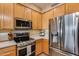 Stainless steel appliances and light wood cabinets in kitchen at 11022 N Indigo Dr # 127, Fountain Hills, AZ 85268