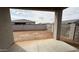 View of an enclosed backyard with concrete patio and block wall in a residential neighborhood at 11453 E Utah Ave, Mesa, AZ 85212