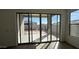 View through sliding glass doors into the backyard which features a block wall and patio at 11453 E Utah Ave, Mesa, AZ 85212