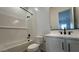 Bathroom featuring tiled shower and tub, modern vanity with sink and matte black hardware at 11453 E Utah Ave, Mesa, AZ 85212