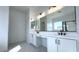 Bathroom featuring dual sinks, quartz counters, chrome hardware and hexagon tile floor at 11453 E Utah Ave, Mesa, AZ 85212