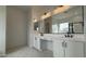 Bathroom featuring dual sinks, vanity area, and contemporary finishes at 11453 E Utah Ave, Mesa, AZ 85212