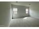 Bright bedroom with neutral carpet and large windows, creating a comfortable atmosphere at 11453 E Utah Ave, Mesa, AZ 85212