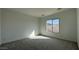 Bedroom with carpet, white walls and a window at 11453 E Utah Ave, Mesa, AZ 85212