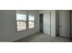 Bedroom featuring carpet, closet, and a wall of two windows that provide natural light at 11453 E Utah Ave, Mesa, AZ 85212