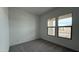 Bright, carpeted bedroom featuring dual windows and ample natural light at 11453 E Utah Ave, Mesa, AZ 85212