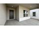 Covered entryway featuring a dark front door and a large window with bench seating at 11453 E Utah Ave, Mesa, AZ 85212