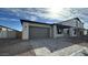 Exterior view of home showing the garage, entryway and desert landscaping at 11453 E Utah Ave, Mesa, AZ 85212