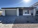 New construction home with gray garage doors and a paved driveway at 11453 E Utah Ave, Mesa, AZ 85212