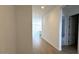 Hallway with tiled floors leading to the kitchen and bedrooms at 11453 E Utah Ave, Mesa, AZ 85212