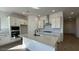 This kitchen features an island, a stainless steel hood, white cabinets and tile flooring at 11453 E Utah Ave, Mesa, AZ 85212