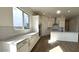 This kitchen features an island, a stainless steel hood, white cabinets, and tile flooring at 11453 E Utah Ave, Mesa, AZ 85212