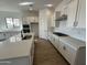 Modern kitchen with white cabinets, quartz countertops, and an island at 11453 E Utah Ave, Mesa, AZ 85212