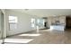 Living room features tile floors and an open concept layout to the kitchen with lots of light from big windows at 11453 E Utah Ave, Mesa, AZ 85212