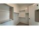 Well-organized walk-in closet with shelving and a door, maximizing storage space at 11453 E Utah Ave, Mesa, AZ 85212