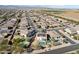 Aerial view of a house with solar panels and a pool in a residential neighborhood near mountains at 12053 N 157Th Ave, Surprise, AZ 85379