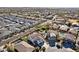 Aerial view of a house with solar panels and a pool in a neighborhood with other homes at 12053 N 157Th Ave, Surprise, AZ 85379