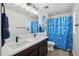 Bathroom with a double vanity and blue shower curtain at 12053 N 157Th Ave, Surprise, AZ 85379