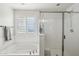 Bathroom boasts a soaking tub, shower, and large window at 12053 N 157Th Ave, Surprise, AZ 85379