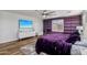 Purple-walled bedroom with a queen bed and floating shelves at 12053 N 157Th Ave, Surprise, AZ 85379