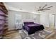 Purple-walled bedroom with a queen bed and floating shelves at 12053 N 157Th Ave, Surprise, AZ 85379