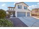 Two-story house with a three-car garage and desert landscaping at 12053 N 157Th Ave, Surprise, AZ 85379