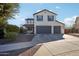 Two-story home with a three-car garage and landscaped yard at 12053 N 157Th Ave, Surprise, AZ 85379