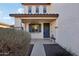 Charming front porch with a blue door and small bench at 12053 N 157Th Ave, Surprise, AZ 85379