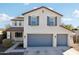 Two-story house with gray garage doors and solar panels at 12053 N 157Th Ave, Surprise, AZ 85379