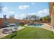 Relaxing pool area with patio furniture and grassy lawn at 12053 N 157Th Ave, Surprise, AZ 85379