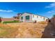 Large backyard with artificial turf, playground equipment, and a privacy wall at 12105 W Luxton Ln, Avondale, AZ 85323