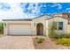 New stucco home with tile roof, 2-car garage, and desert landscaping at 12105 W Luxton Ln, Avondale, AZ 85323