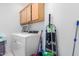 Bright laundry room with washer, dryer, and ample cabinet storage at 12105 W Luxton Ln, Avondale, AZ 85323