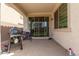 Covered patio with sliding glass doors, a grill, and outdoor seating at 12105 W Luxton Ln, Avondale, AZ 85323